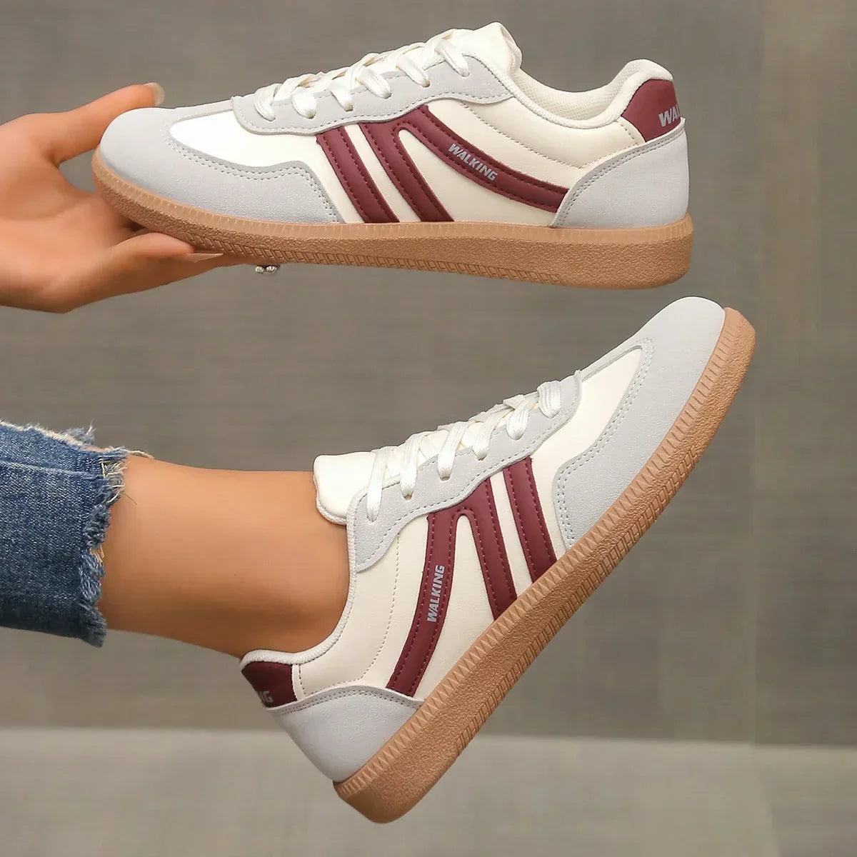 "Women's modern low-top lace-up sneakers with chic side stripes, perfect for casual attire and sporty wear."