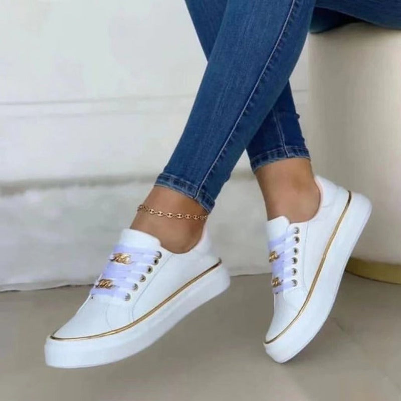 Women's platform sneakers with bold gold chain, round toe, and lace-up closure; stylish design suitable for all seasons.