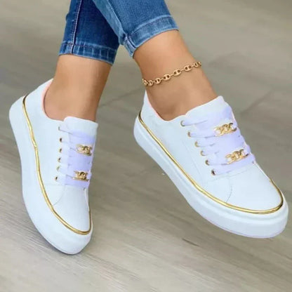 Women's platform sneakers with bold gold chain, round toe, and lace-up closure; stylish design suitable for all seasons.