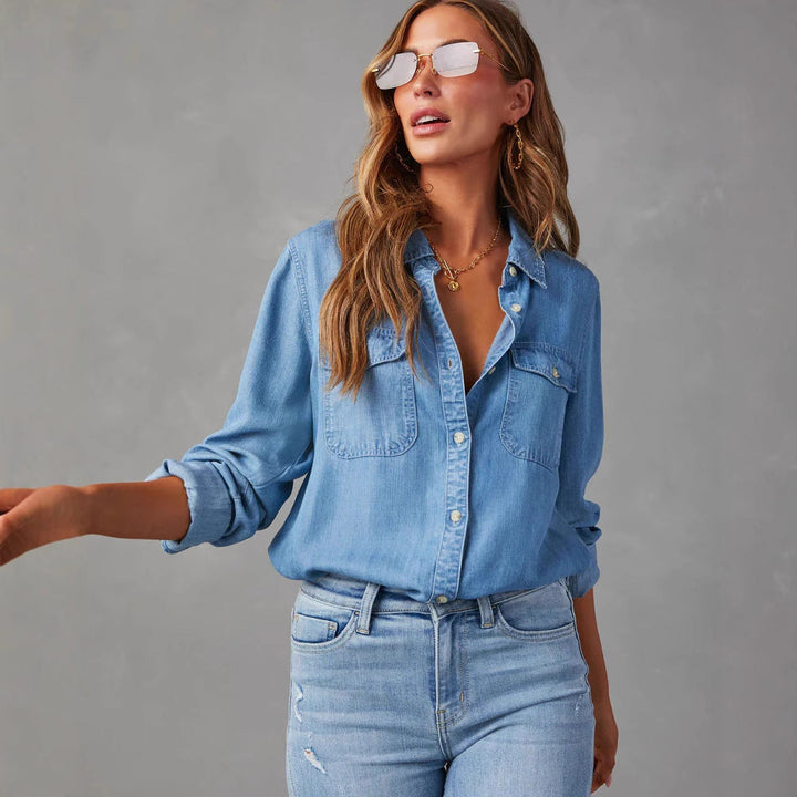"Women's relaxed fit denim shirt with button-down front, chest pockets, in light blue, perfect for casual elegance."