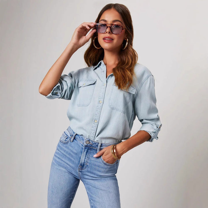 "Women's relaxed fit denim shirt with button-down front, chest pockets, in light blue, perfect for casual elegance."