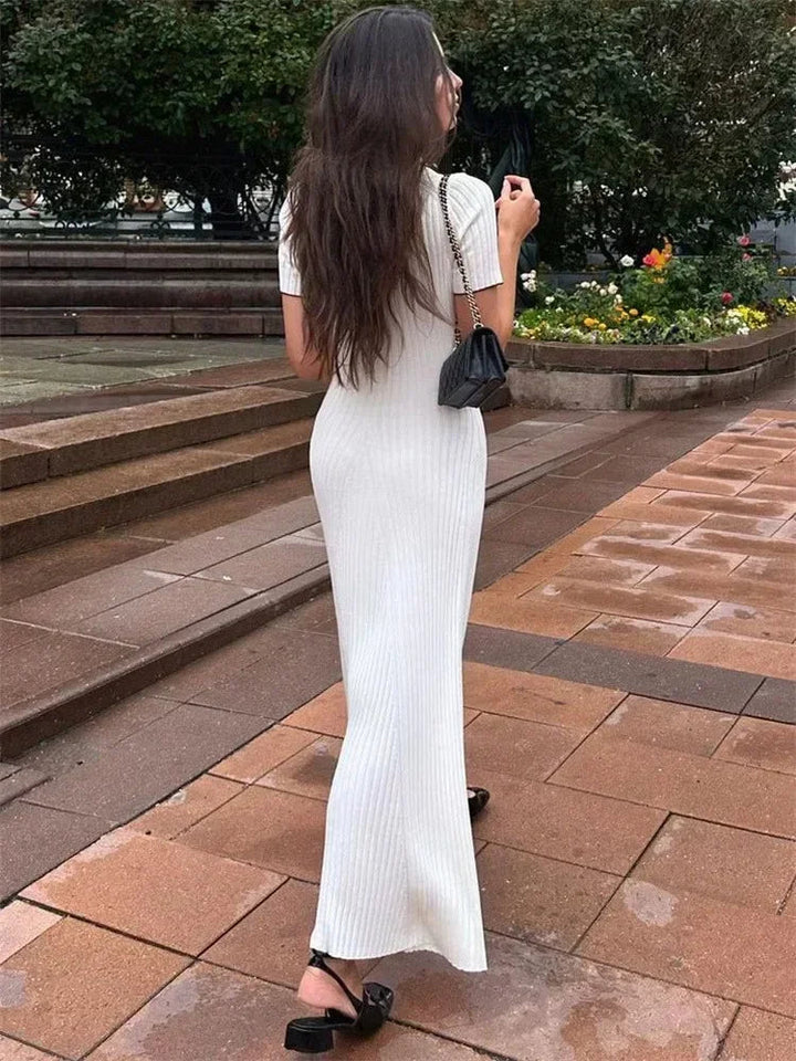 "Women's ribbed knit maxi dress with collared V-neck, button details, and flowing silhouette in versatile colors."