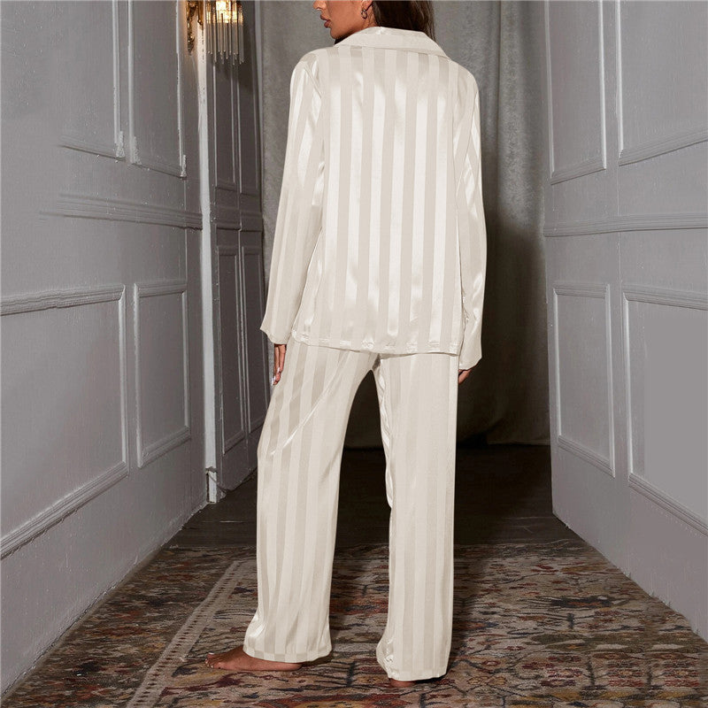 "Women's silk-feel pyjama set, front view: luxurious loungewear with button-down top, matching trousers, elegant sheen."