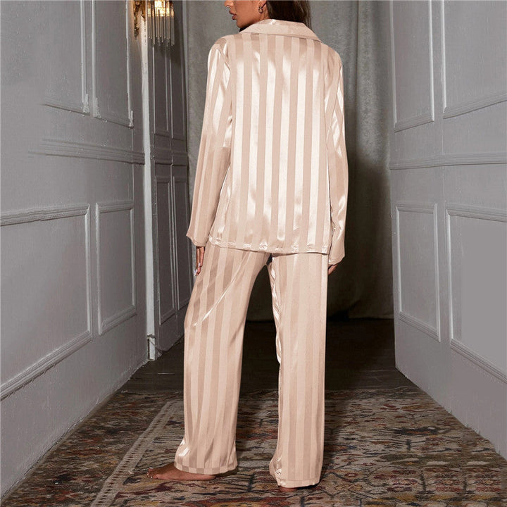 "Women's silk-feel pyjama set, front view: luxurious loungewear with button-down top, matching trousers, elegant sheen."