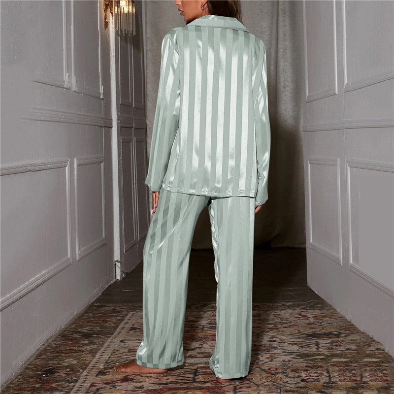 "Women's silk-feel pyjama set, front view: luxurious loungewear with button-down top, matching trousers, elegant sheen."