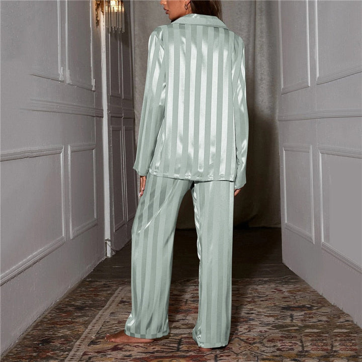 "Women's silk-feel pyjama set, front view: luxurious loungewear with button-down top, matching trousers, elegant sheen."