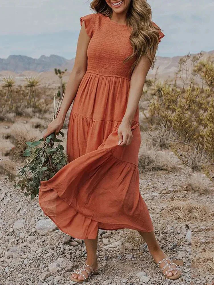 Women's sleeveless smocked midi dress with A-line skirt, airy fabric, perfect for summer occasions. Elegant and comfortable.
