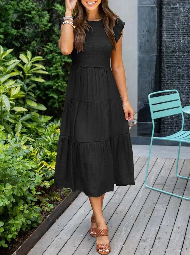 Women's sleeveless smocked midi dress with A-line skirt, airy fabric, perfect for summer occasions. Elegant and comfortable.