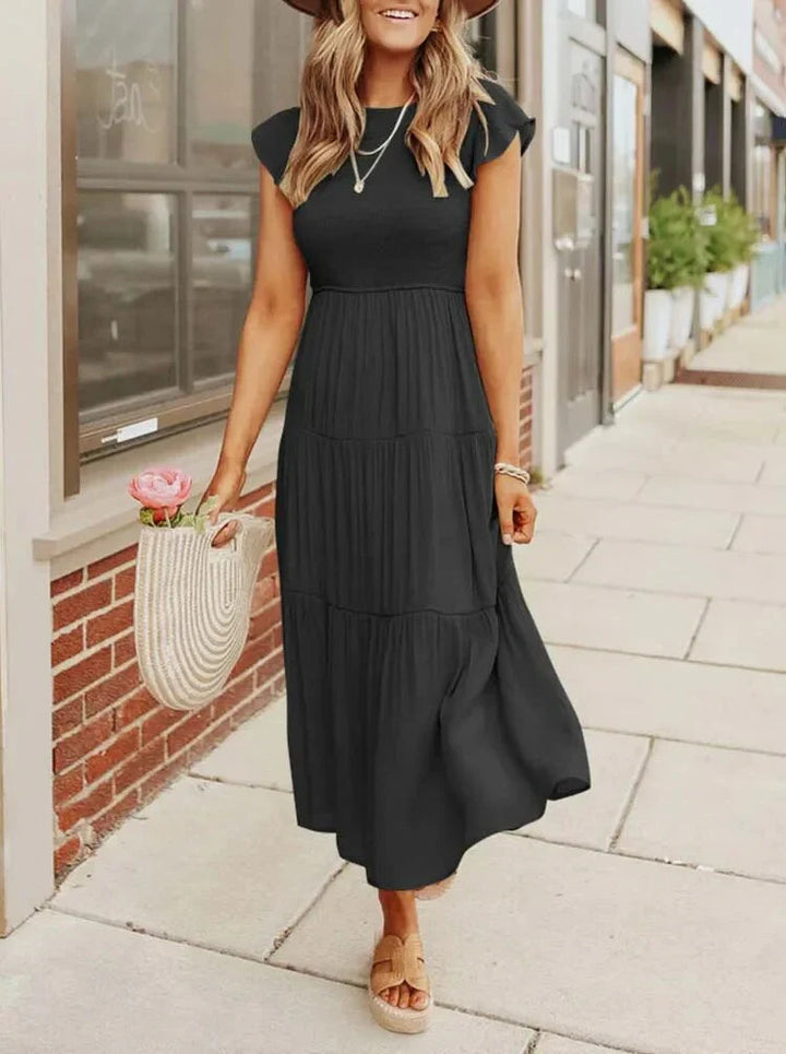Women's sleeveless smocked midi dress with A-line skirt, airy fabric, perfect for summer occasions. Elegant and comfortable.