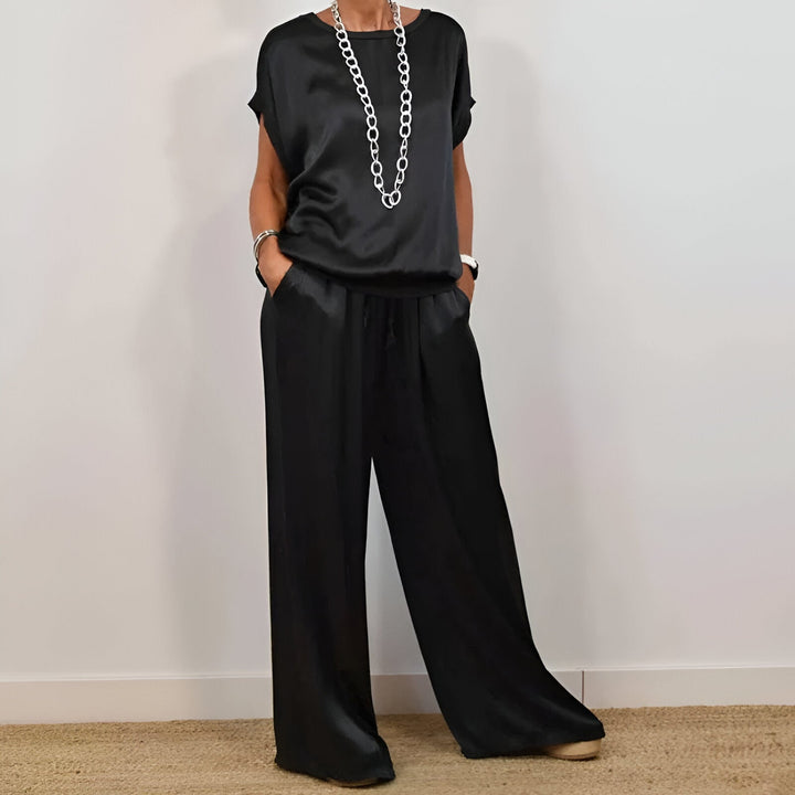 "Women's soft co-ord set with wide-leg trousers and short sleeve top in neutral hues, depicting elegance and comfort."