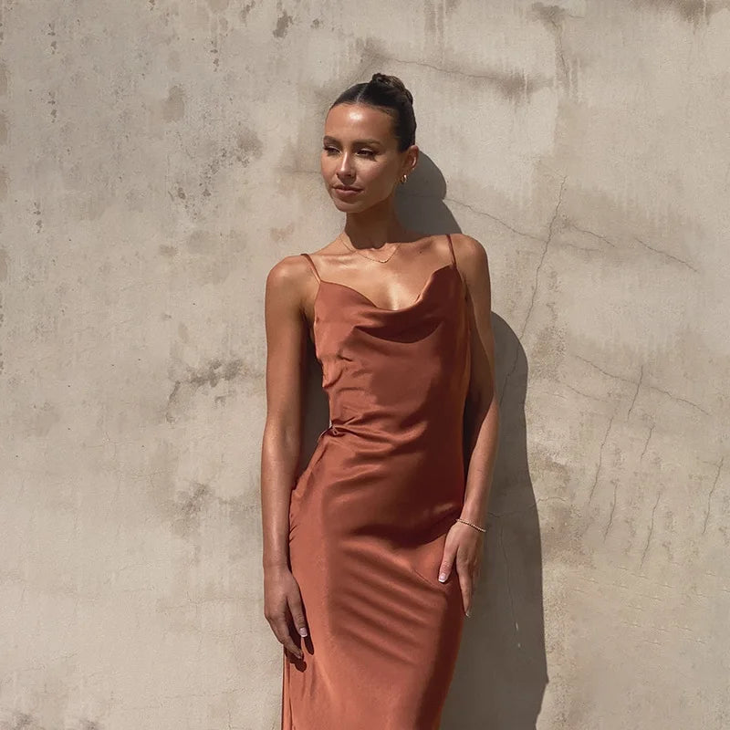 Women's spaghetti strap draped maxi dress, floor-length, fluid neckline, flattering silhouette, ideal for formal events.