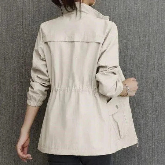 Women's spring trench coat, khaki, mid-length, with adjustable waist and button-down closure, perfect for breezy days.