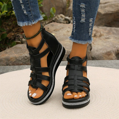 Women's strappy platform sandals with ankle coverage, bold multi-strap design, flat platform sole, back zip closure.