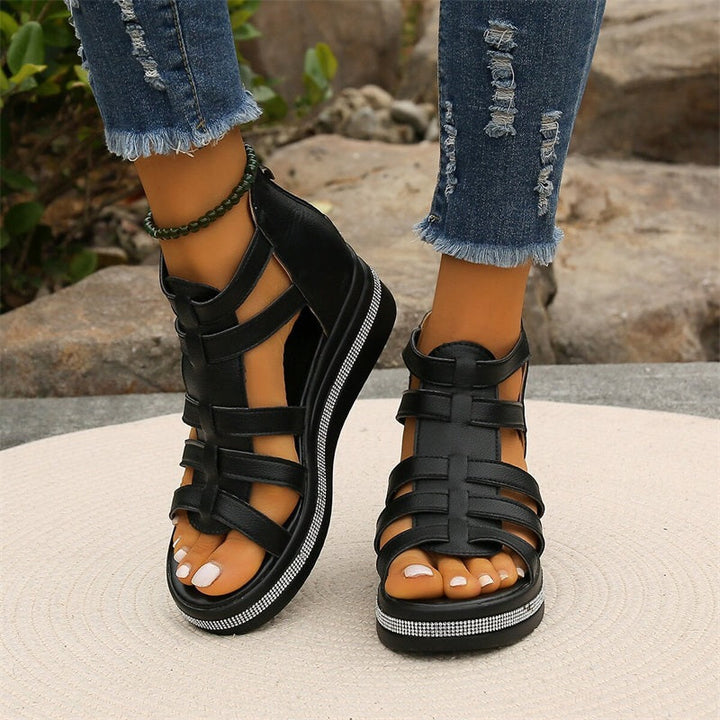 Women's strappy platform sandals with ankle coverage, bold multi-strap design, flat platform sole, back zip closure.