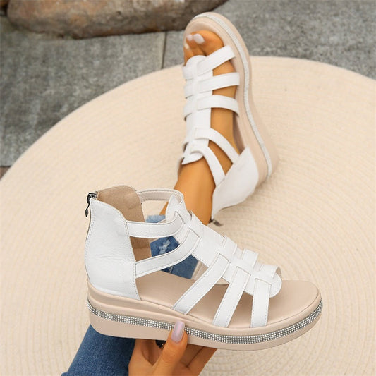Women's strappy platform sandals with ankle coverage, bold multi-strap design, flat platform sole, back zip closure.