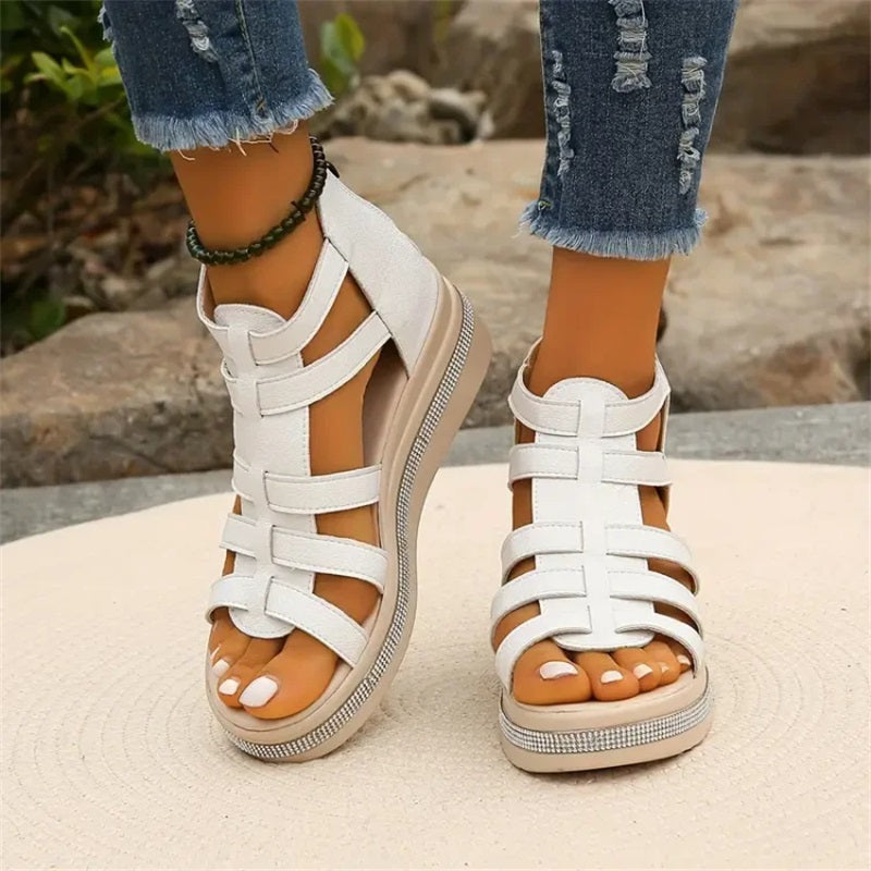 Women's strappy platform sandals with ankle coverage, bold multi-strap design, flat platform sole, back zip closure.