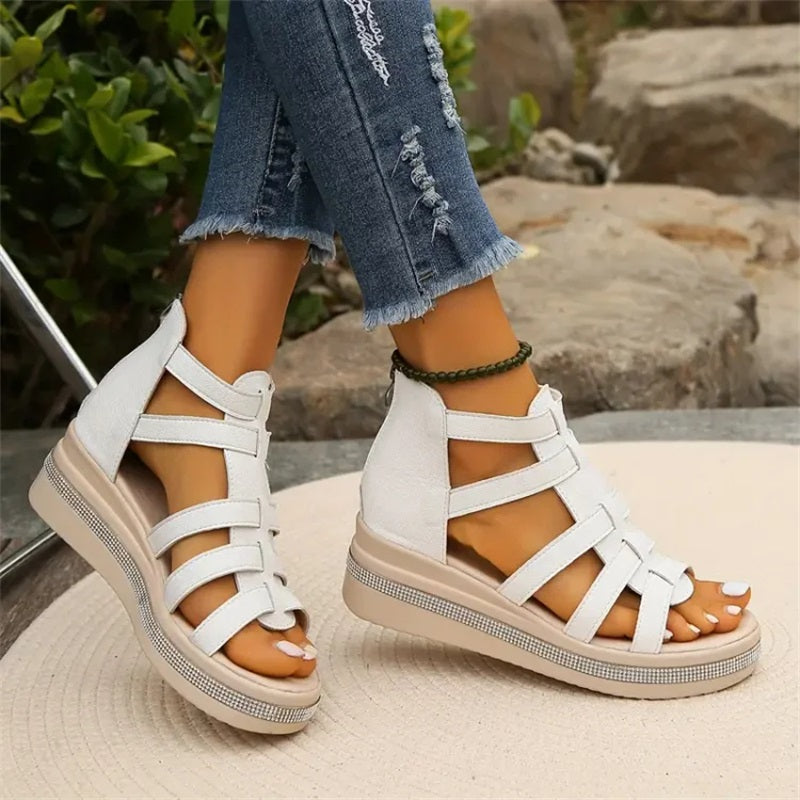 Women's strappy platform sandals with ankle coverage, bold multi-strap design, flat platform sole, back zip closure.