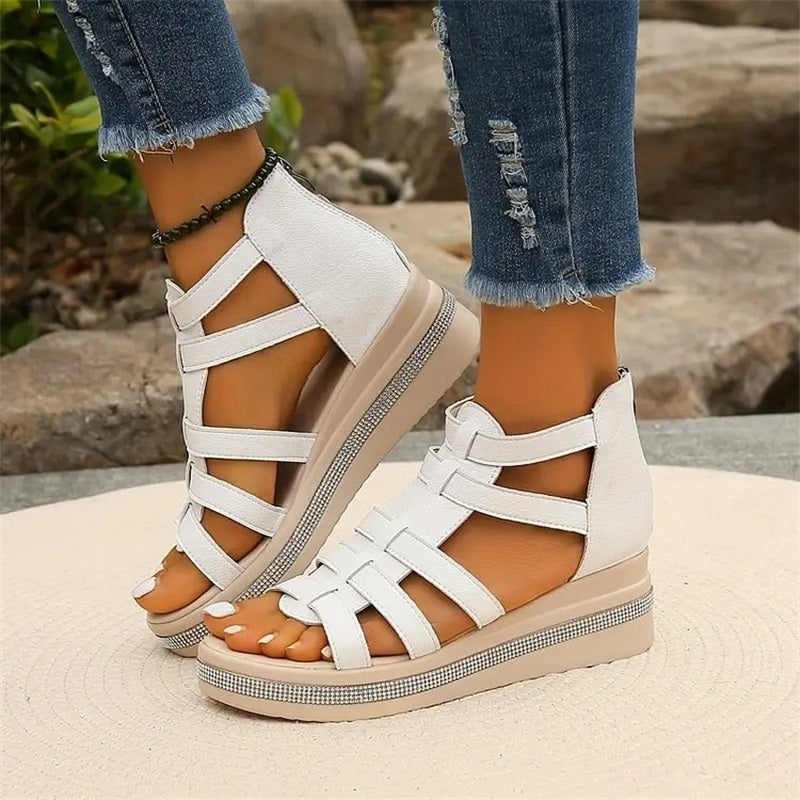 Women's strappy platform sandals with ankle coverage, bold multi-strap design, flat platform sole, back zip closure.