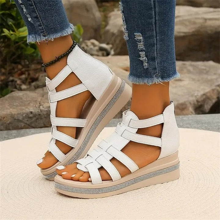 Women's strappy platform sandals with ankle coverage, bold multi-strap design, flat platform sole, back zip closure.