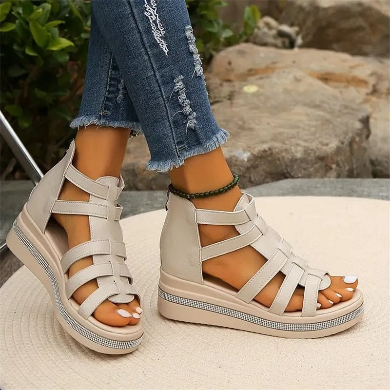 Women's strappy platform sandals with ankle coverage, bold multi-strap design, flat platform sole, back zip closure.