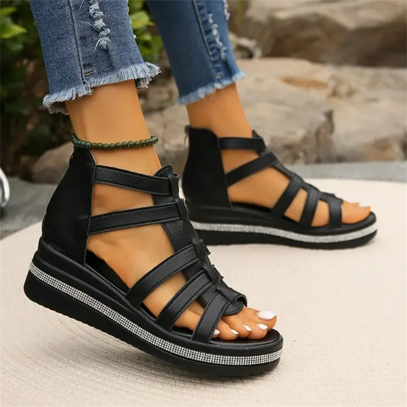 Women's strappy platform sandals with ankle coverage, bold multi-strap design, flat platform sole, back zip closure.