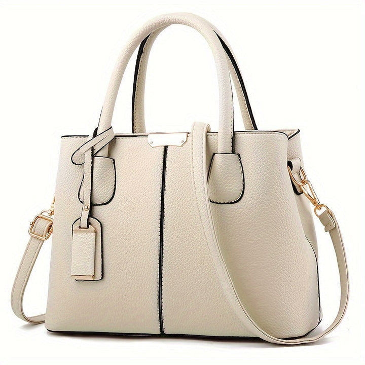 Women's stylish leather handbag with tote design, detachable crossbody strap, gold accents, spacious interior, elegant look.