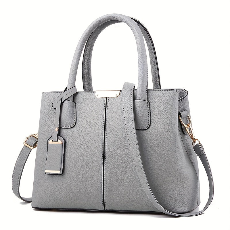 Women's stylish leather handbag with tote design, detachable crossbody strap, gold accents, spacious interior, elegant look.
