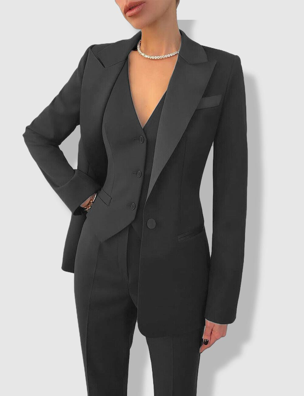 Women's tailored suit with notch lapels, blazer with button closure, and matching trousers in a polished formal style.