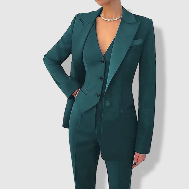 Women's tailored suit with notch lapels, blazer with button closure, and matching trousers in a polished formal style.
