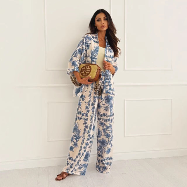 Women's two-piece floral set with a long sleeve top and wide-leg pants, featuring a colorful print and relaxed fit.