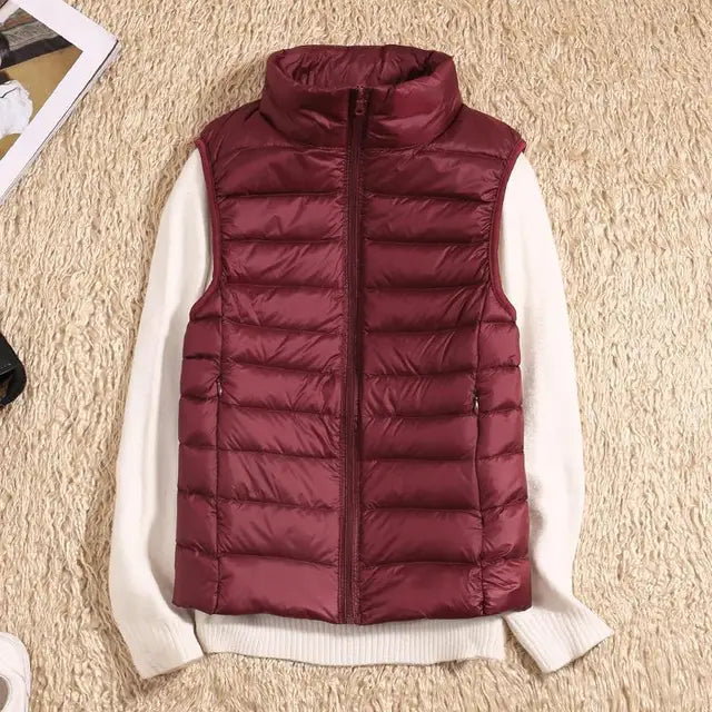 Women's ultra light down vest, warm, lightweight, sleeveless in sleek design, ideal for layering, perfect for chilly days.