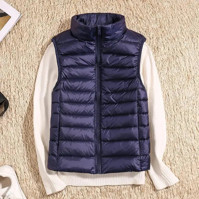 Women's ultra light down vest, warm, lightweight, sleeveless in sleek design, ideal for layering, perfect for chilly days.
