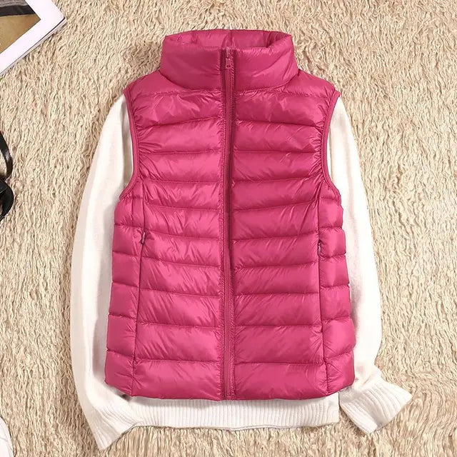 Women's ultra light down vest, warm, lightweight, sleeveless in sleek design, ideal for layering, perfect for chilly days.