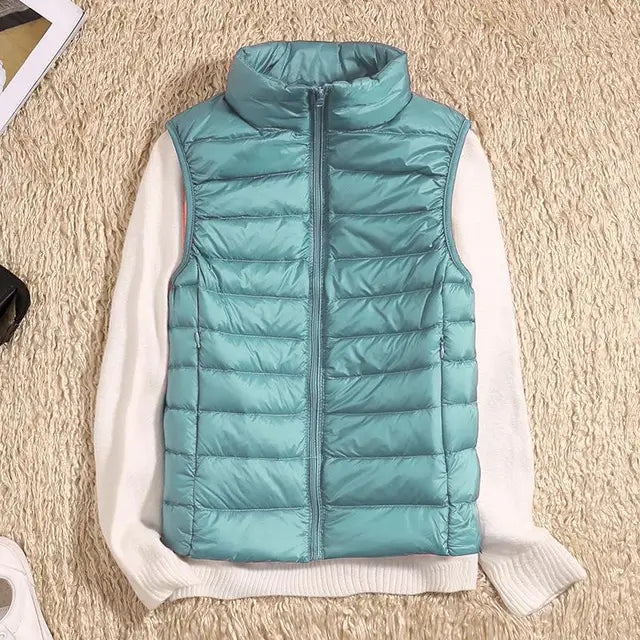Women's ultra light down vest, warm, lightweight, sleeveless in sleek design, ideal for layering, perfect for chilly days.