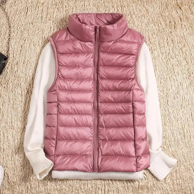 Women's ultra light down vest, warm, lightweight, sleeveless in sleek design, ideal for layering, perfect for chilly days.