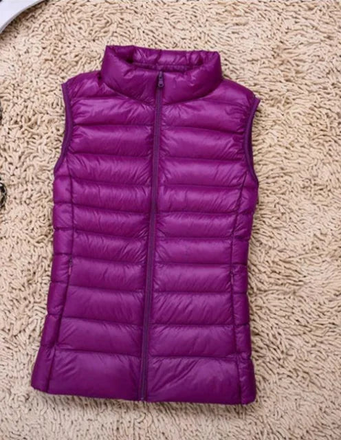 Women's ultra light down vest, warm, lightweight, sleeveless in sleek design, ideal for layering, perfect for chilly days.