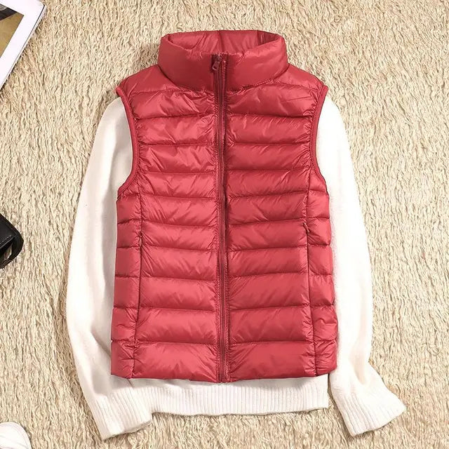 Women's ultra light down vest, warm, lightweight, sleeveless in sleek design, ideal for layering, perfect for chilly days.