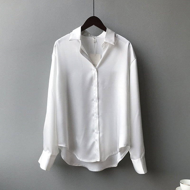 Women's vintage silk blouse with tailored fit, chic design, elegant silhouette, and luxurious lightweight fabric.