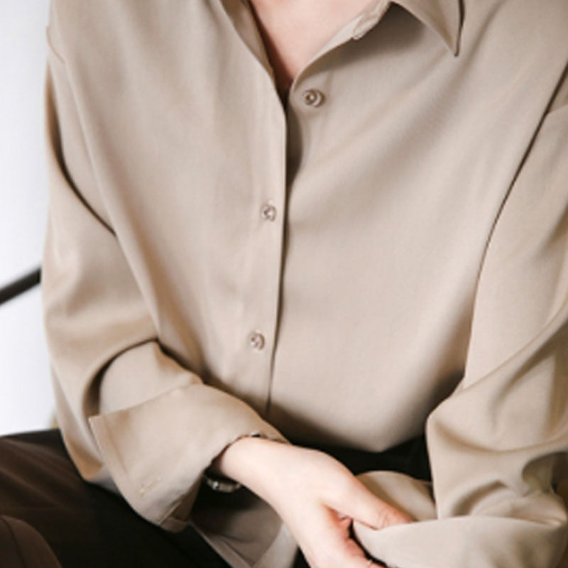 Women's vintage silk blouse with tailored fit, chic design, elegant silhouette, and luxurious lightweight fabric.