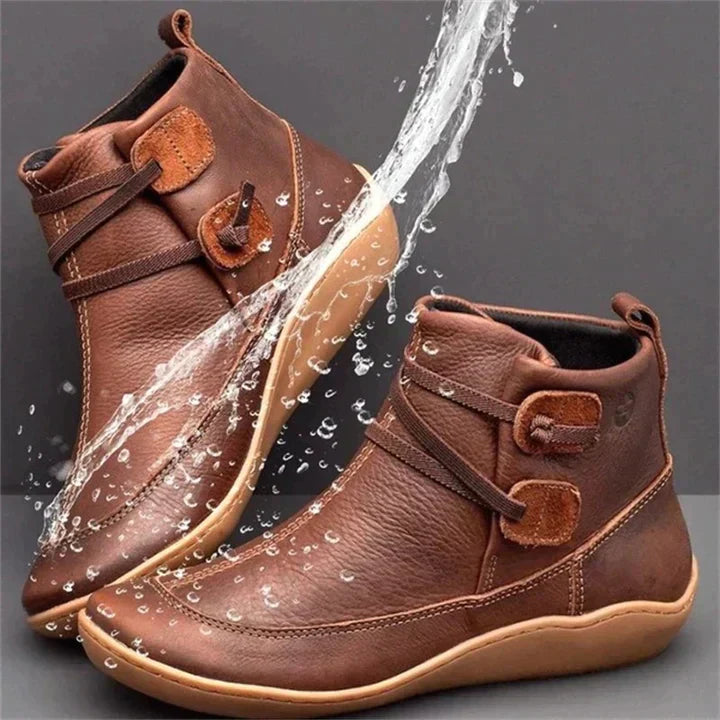 Women's waterproof ankle boots, cushioned interior, non-slip rubber sole, pull-on design, stylish loop strap, round toe.
