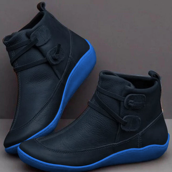 Women's waterproof ankle boots, cushioned interior, non-slip rubber sole, pull-on design, stylish loop strap, round toe.