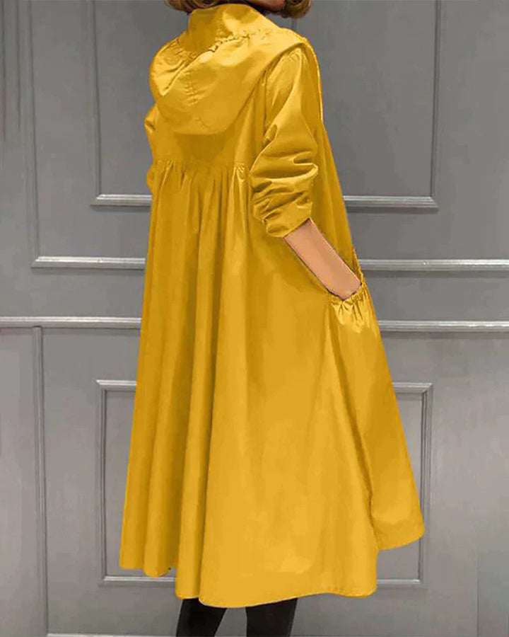 Women's waterproof hooded jacket in knee-length, relaxed fit, shown in lightweight fabric with ruched pockets for stylish cov