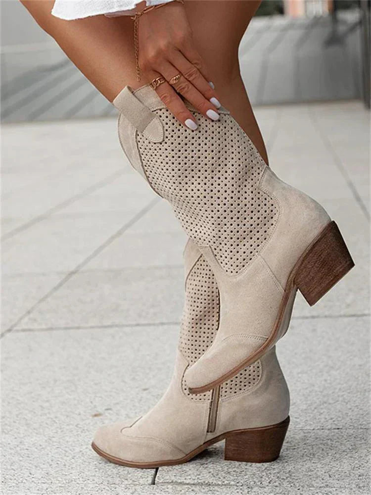 "Women's western ankle boots with pointed toe, block heel, faux leather finish, and pull-on tabs for easy wear."