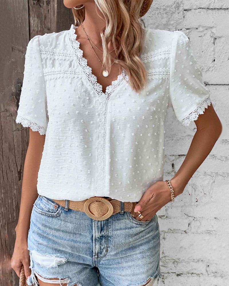 "Women's white textured V-neck summer blouse with lace trim and lightweight fabric, perfect for casual warm-weather outings."