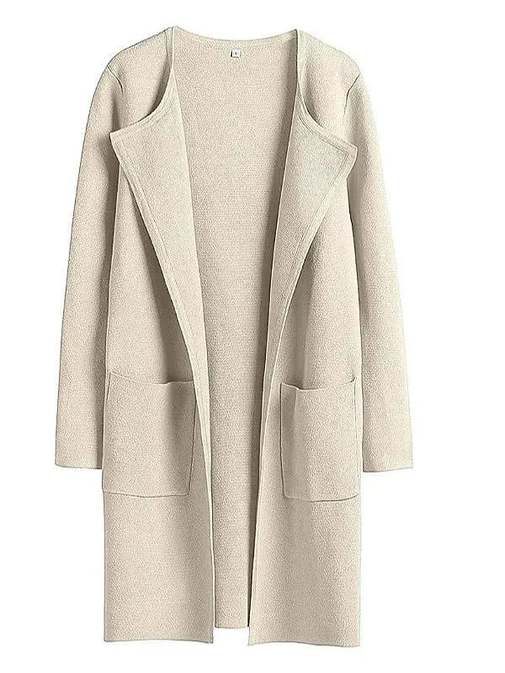 "Women's wool blend knee-length coat with wide lapel and patch pockets, showcasing a relaxed fit and minimalist design."