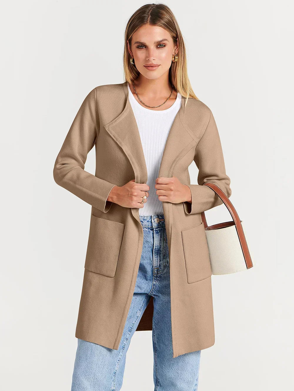 "Women's wool blend knee-length coat with wide lapel and patch pockets, showcasing a relaxed fit and minimalist design."
