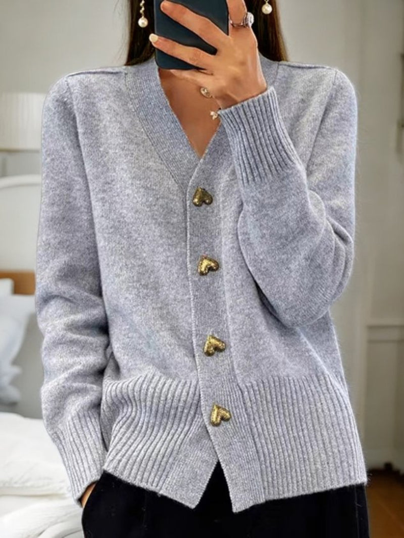 Women's wool cardigan in a solid color with button-up design, long sleeves, and hip-length perfect for winter warmth.